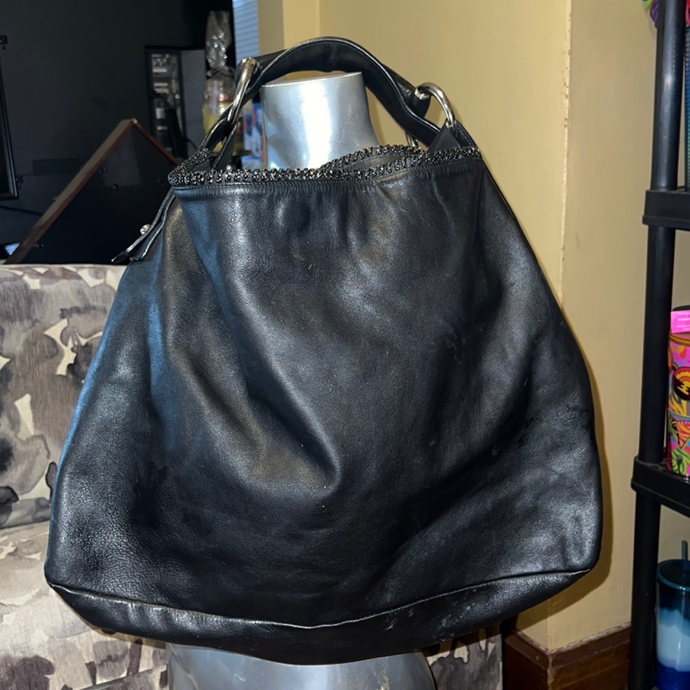 Gucci black leather horse bit purse with magnetic closure.
